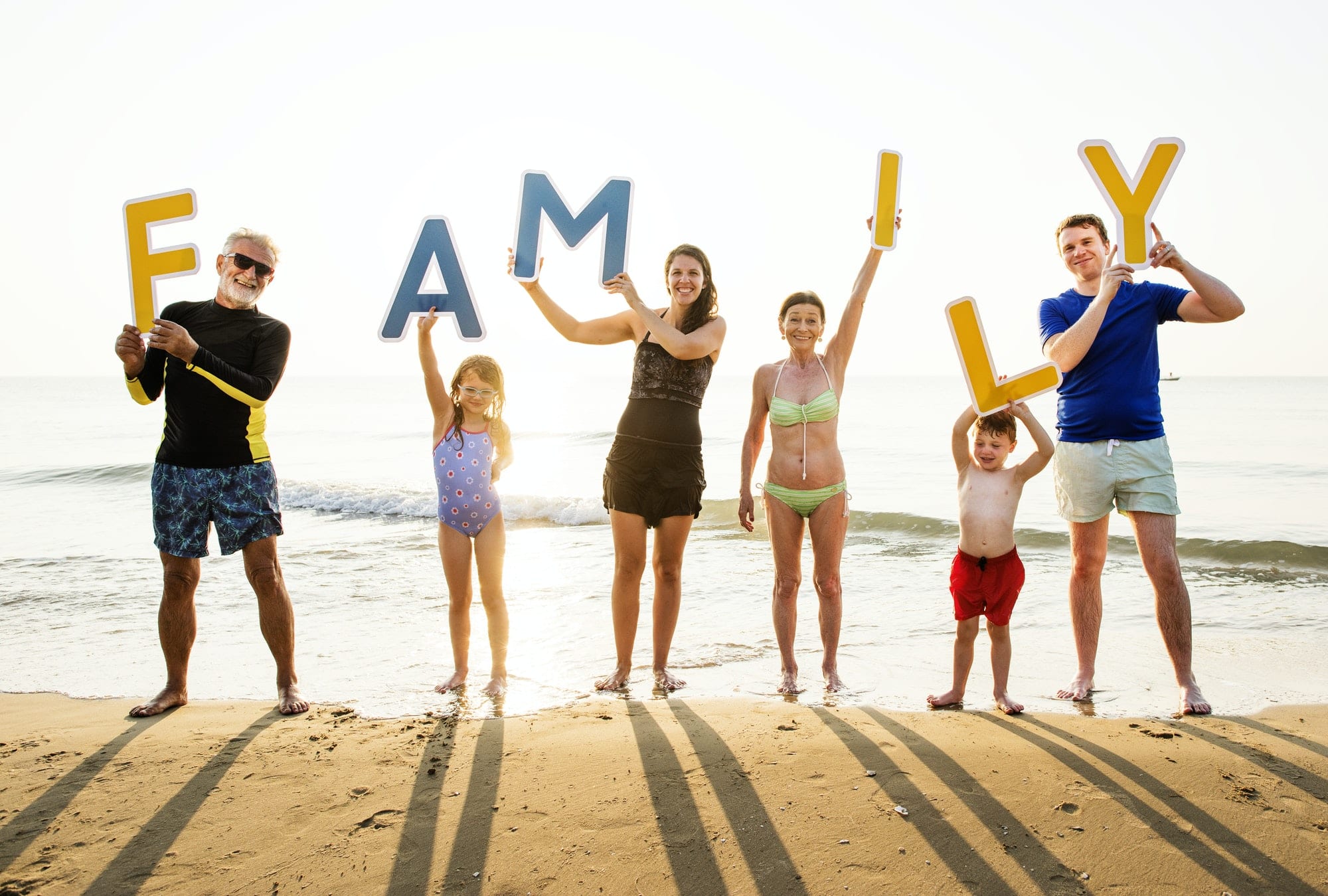 Family holding up the word family