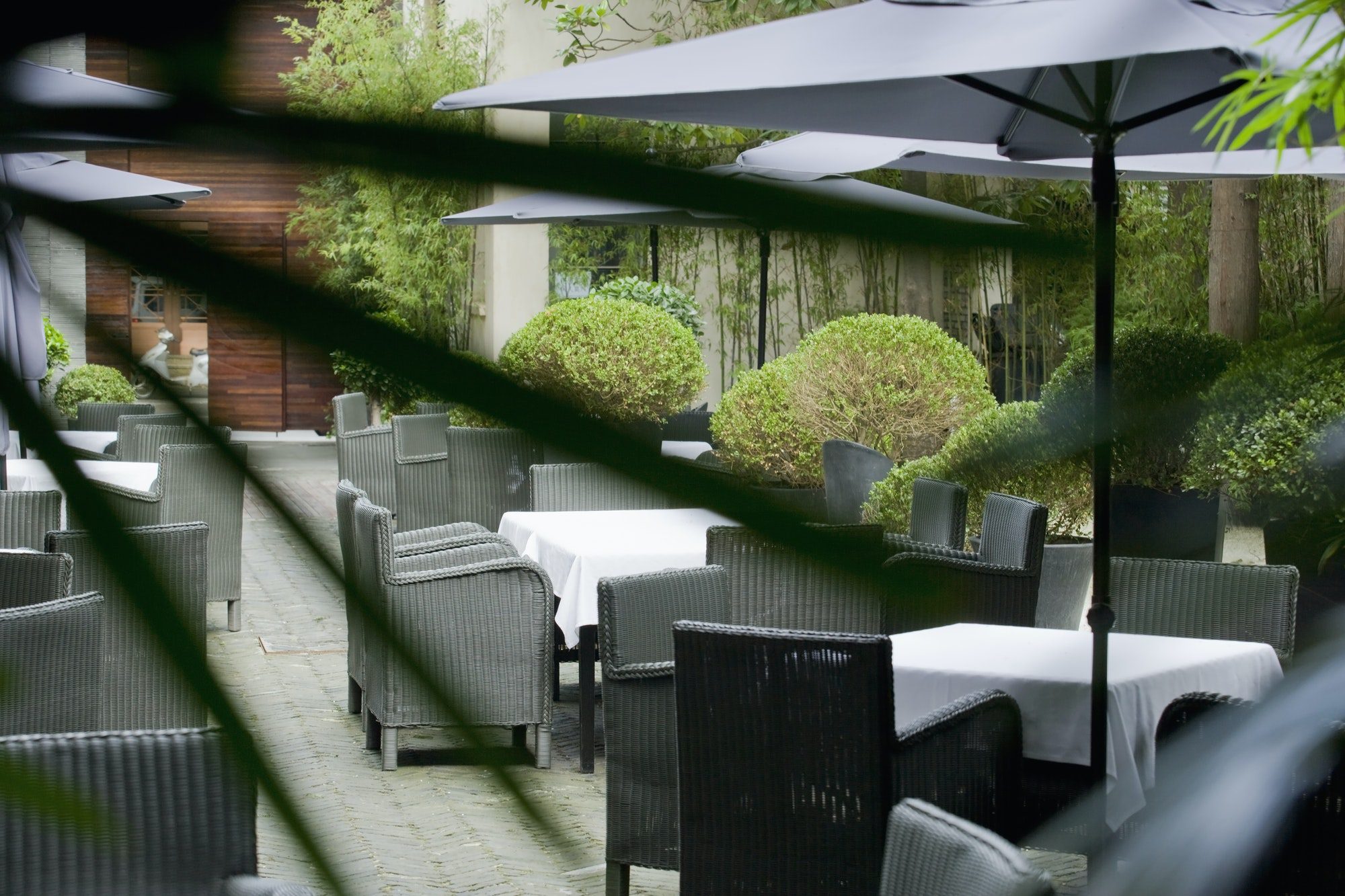 Seating on a paved patio with sun umbrellas