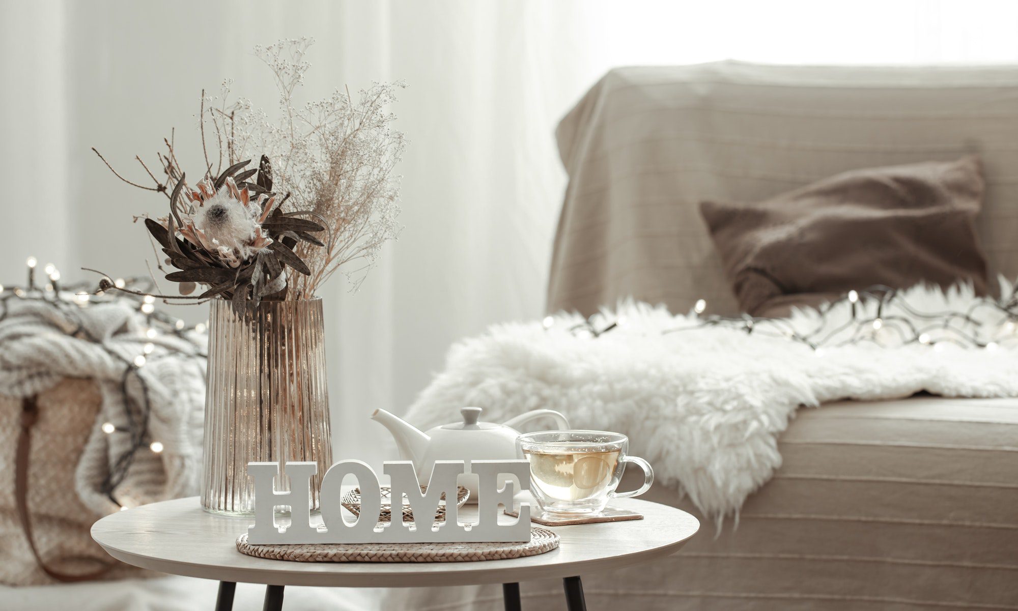 Home composition with decorative word home, tea and decor details.