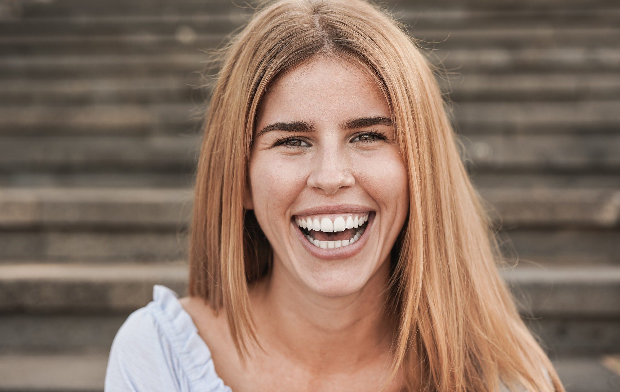 Young caucasian woman smiling on camera outdoor