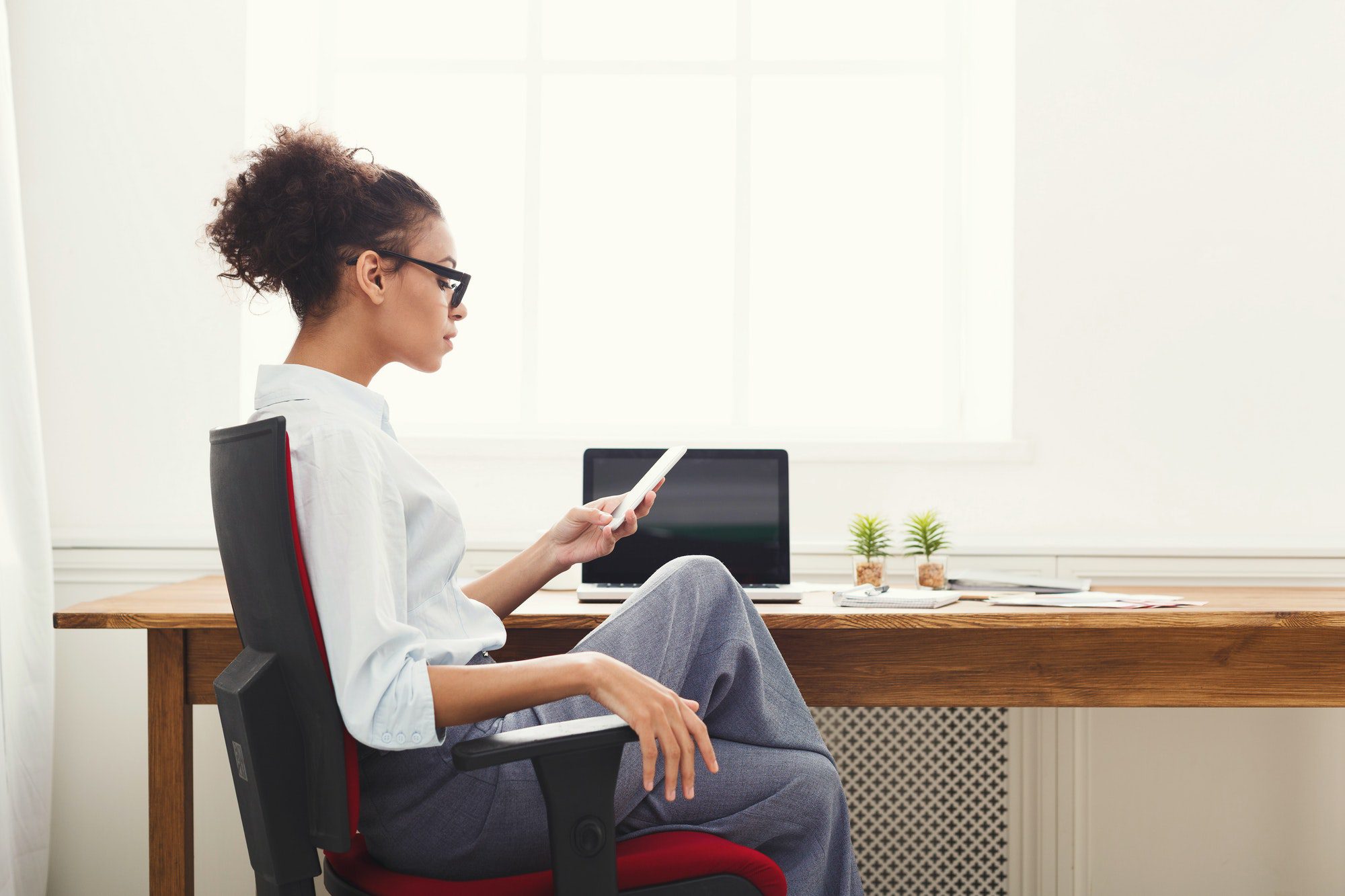 Business woman texting on smartphone