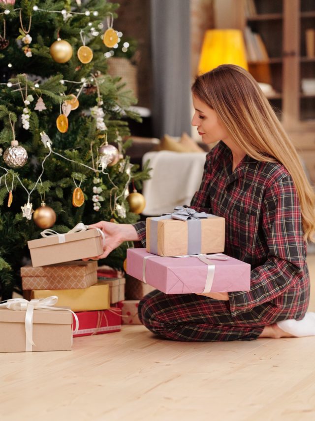 cropped-young-woman-preparing-xmas-gifts-for-her-family-while-putting-them-under-firtree.jpg