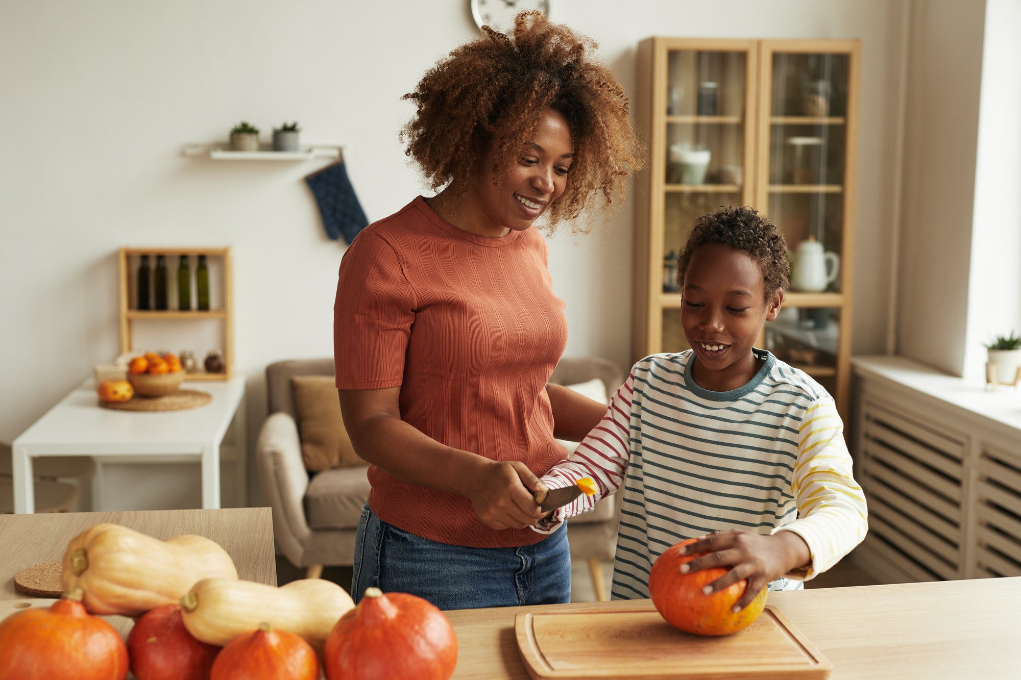 Mom And Kid Starting Pumpkin Carving