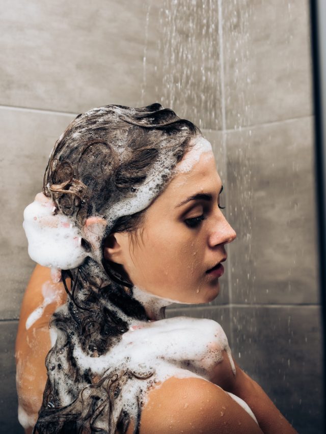 cropped-girl-washing-hair-with-shampoo-in-a-glass-shower-cabin.jpg