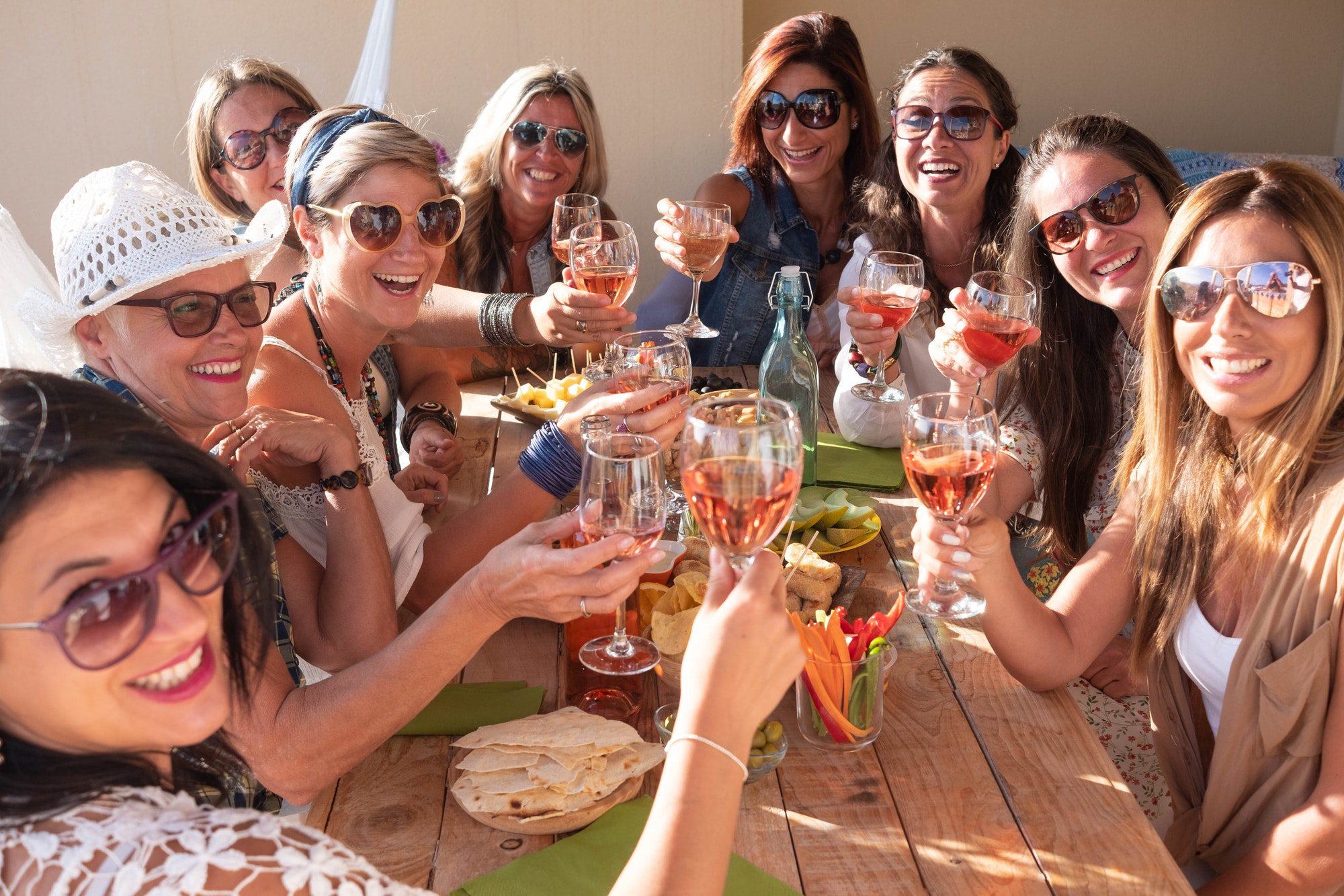 Cheerful women celebrate the party toasting. Happiness and friendship for nine beautiful girls.