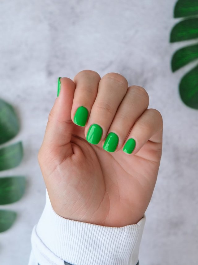 cropped-manicured-female-hands-with-stylish-green-nails-trendy-modern-design-manicure-gel-nails-skin-care.jpg