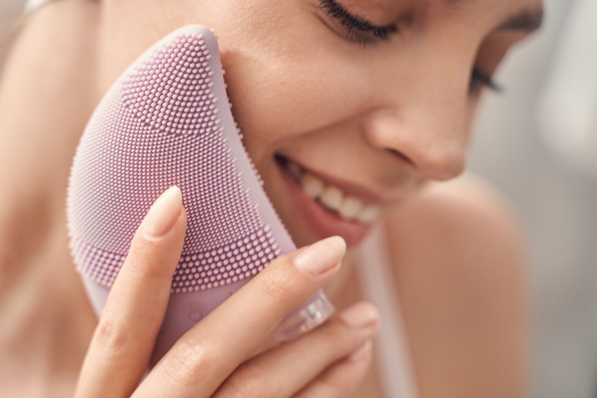 Beautiful Caucasian lady performing an exfoliation procedure