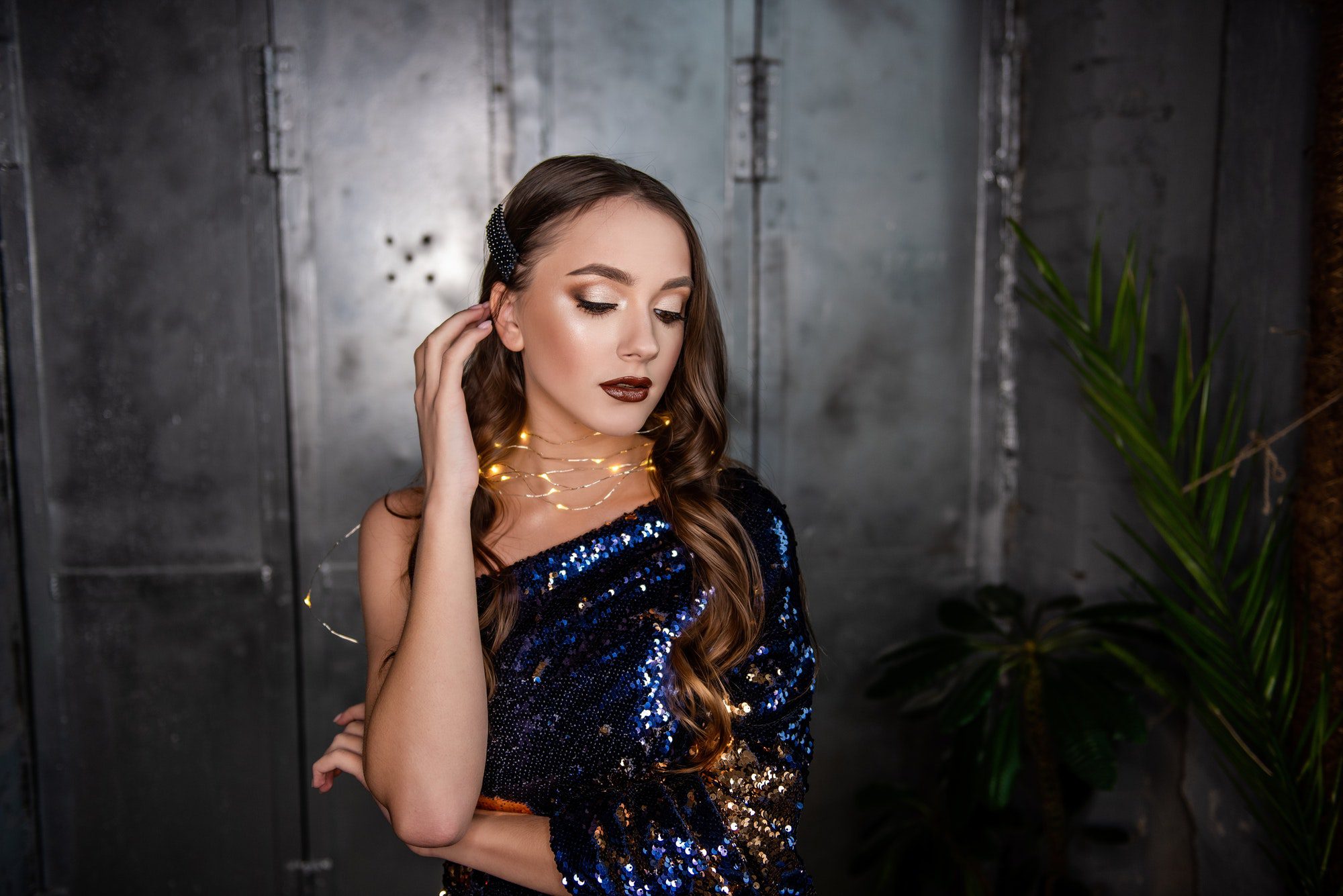 Close-up portrait of beautiful girl with an evening festive, professional make-up, garland around