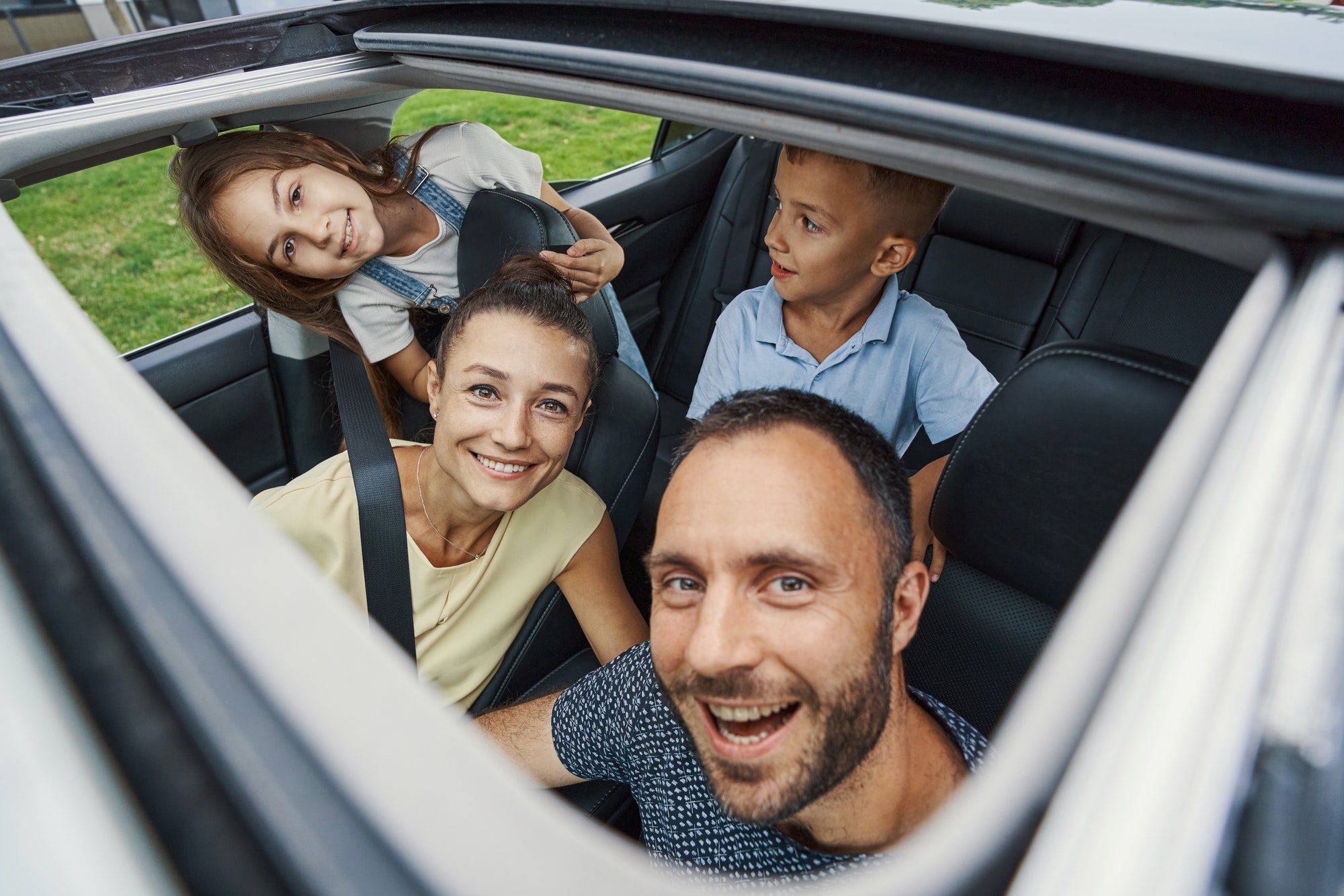 Family of four feeling excited before the road trip