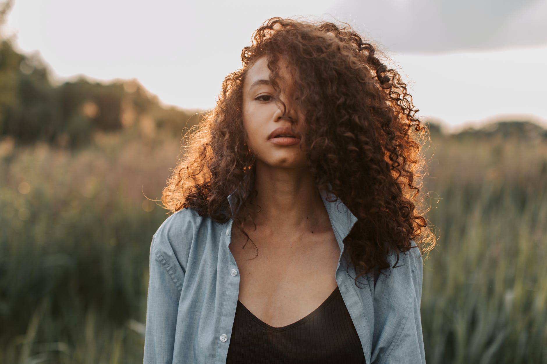 portrait photo of woman with natural curly hair