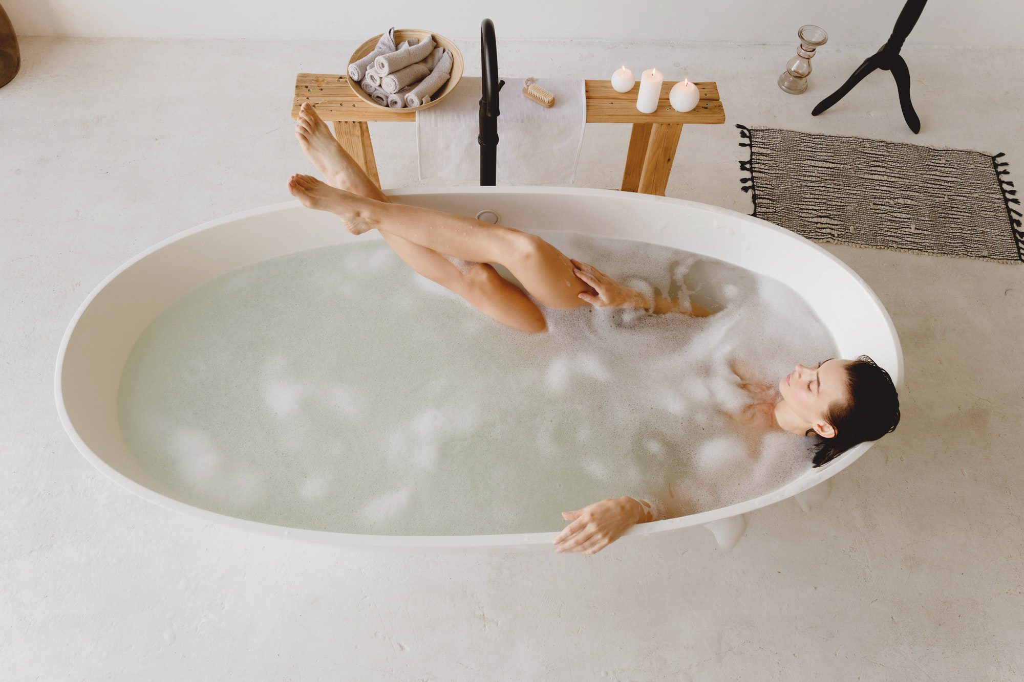 Top view of beautiful woman in the bathtub. Self care concept.