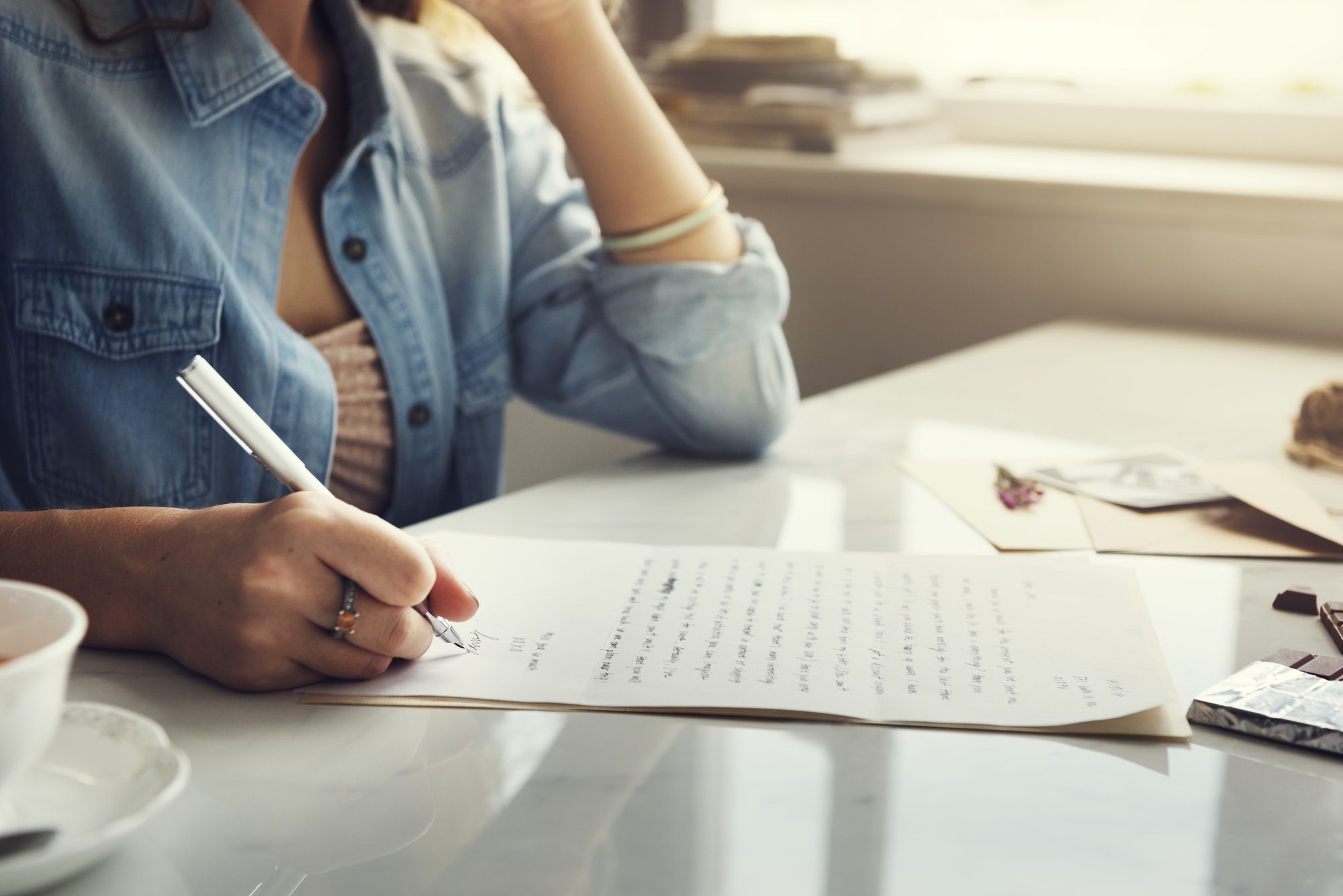 Caucasian woman writing a letter