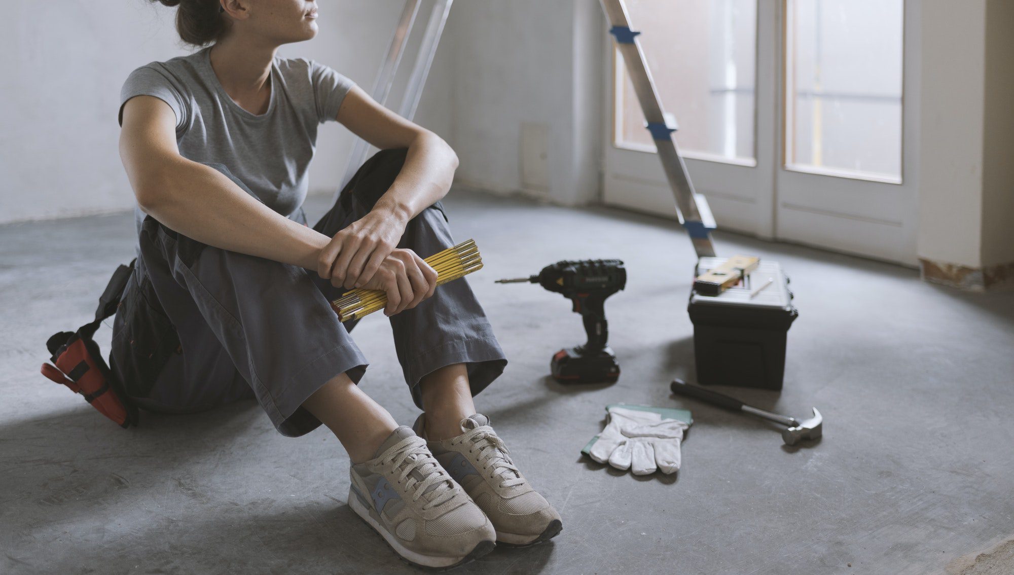 Woman sitting on the floor and planning a home renovation