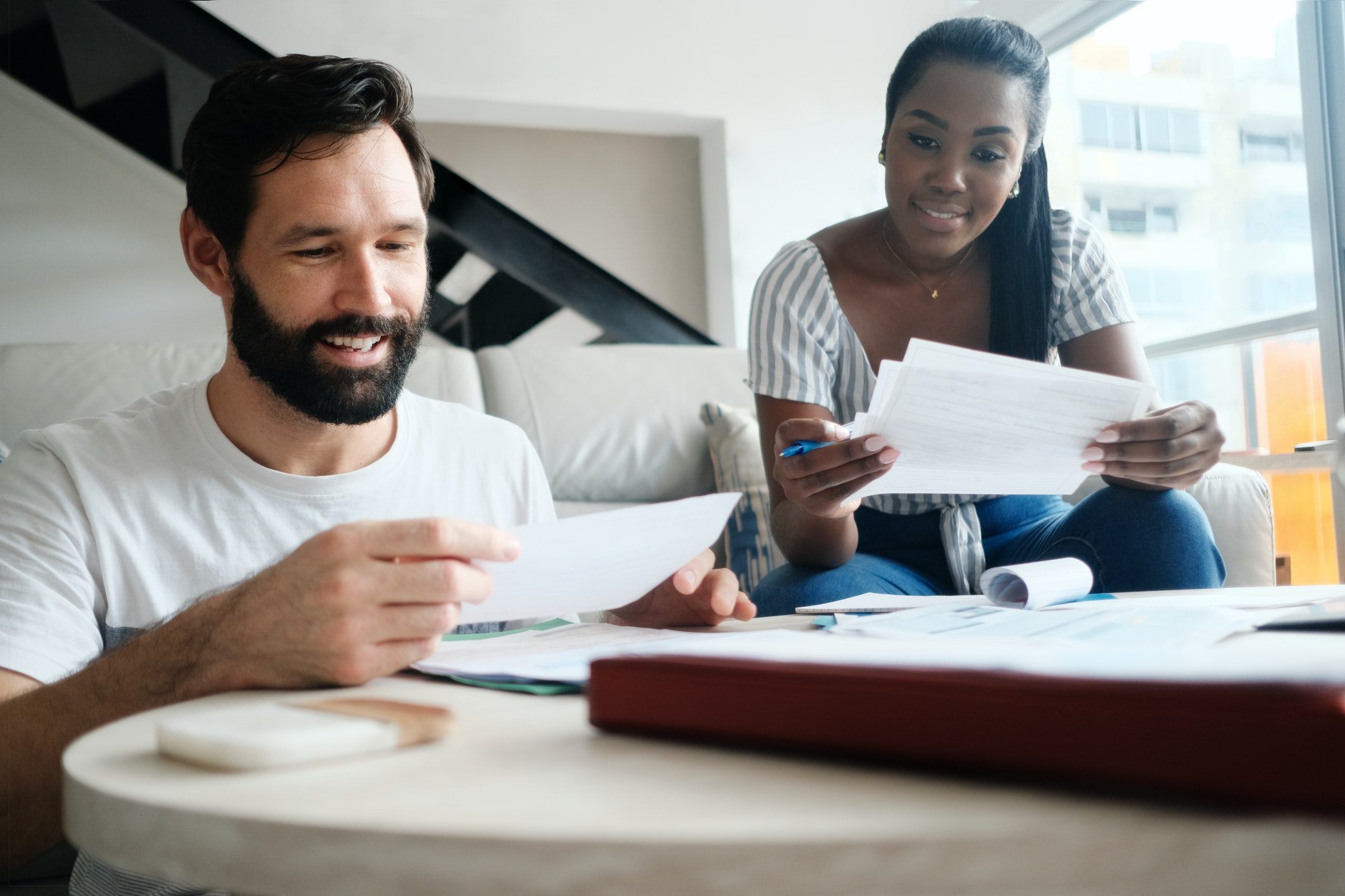 Couple Checking Bills For Home Budget