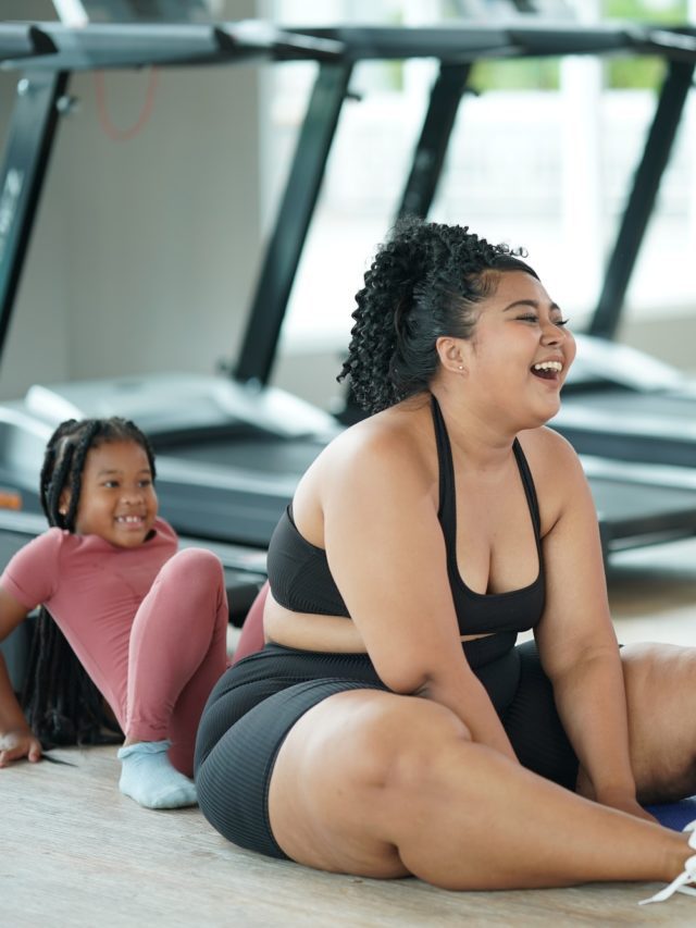 A Fat girl exercise with little girl in fitness to lose size of her belly. Close up.