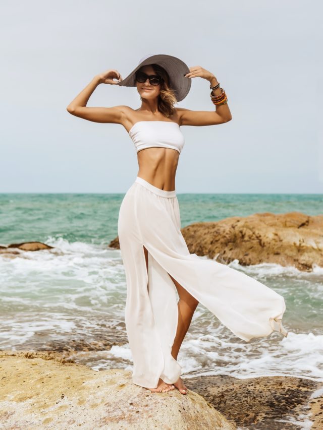 Pretty lady in summer outfit on the beach.