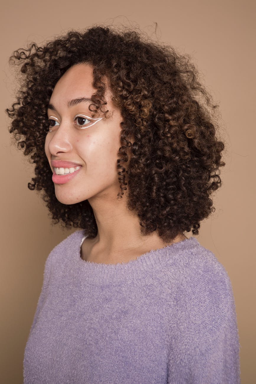 cheerful ethnic woman with white eyeliner