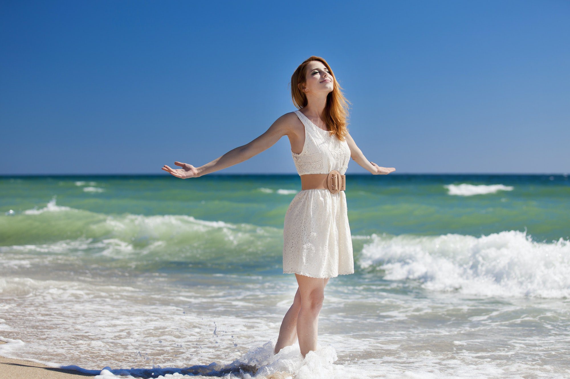 Young redhead girl at the beach.