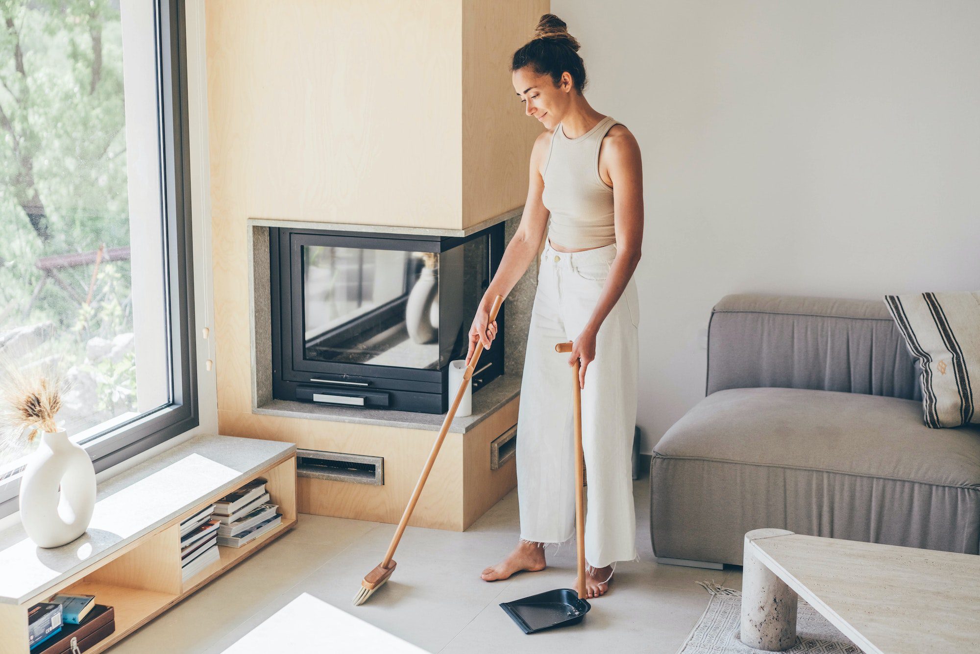 Beautiful housewife enjoys cleaning her home.