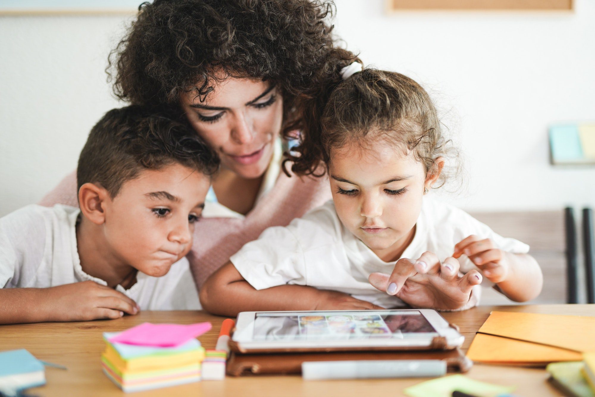 Mother doing home schooling with little children