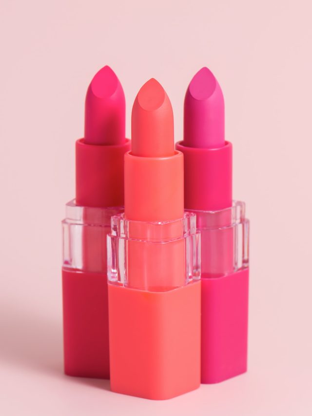 Set of three color lipsticks. Wine lipstick, pink lipstick and orange lipstick in colourful lid.