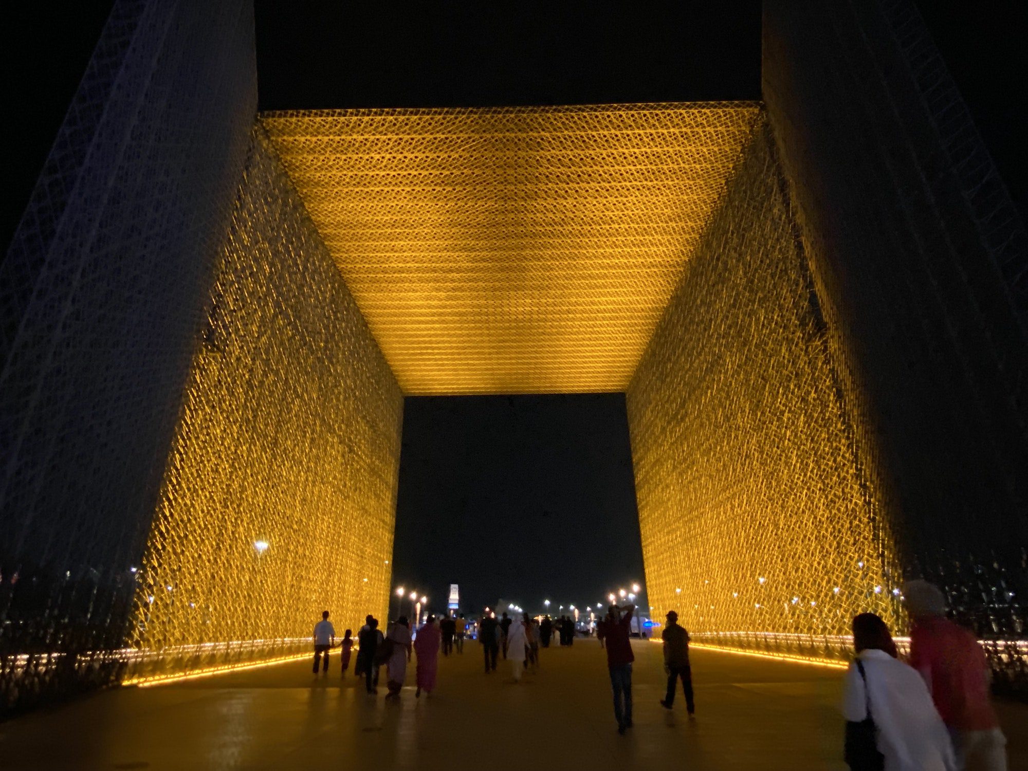 People walking in through golden gate to Expo 2020 Dubai Mobility district