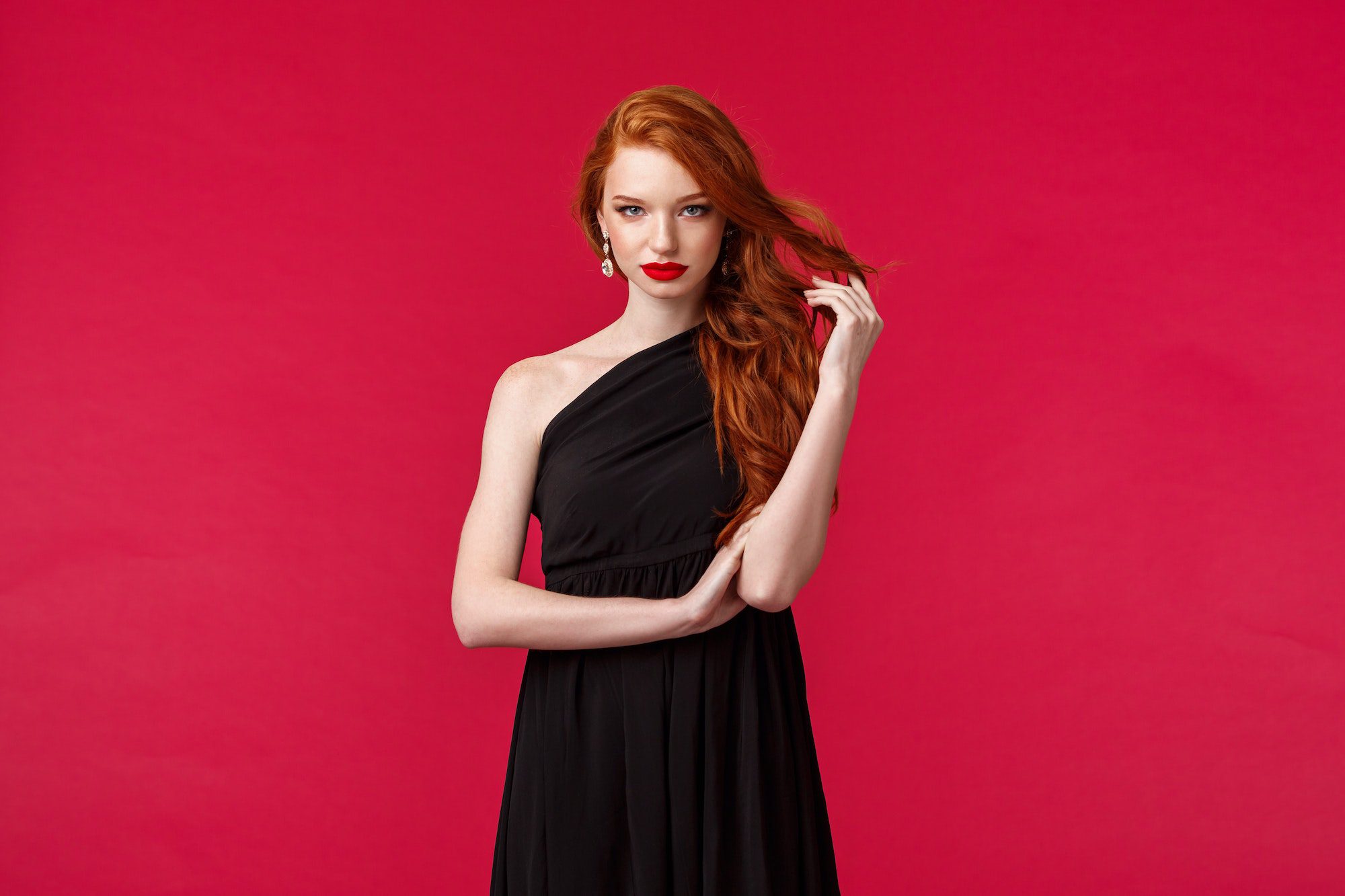 Elegance, fashion and woman concept. Seductive gorgeous redhead woman in black fashionable dress