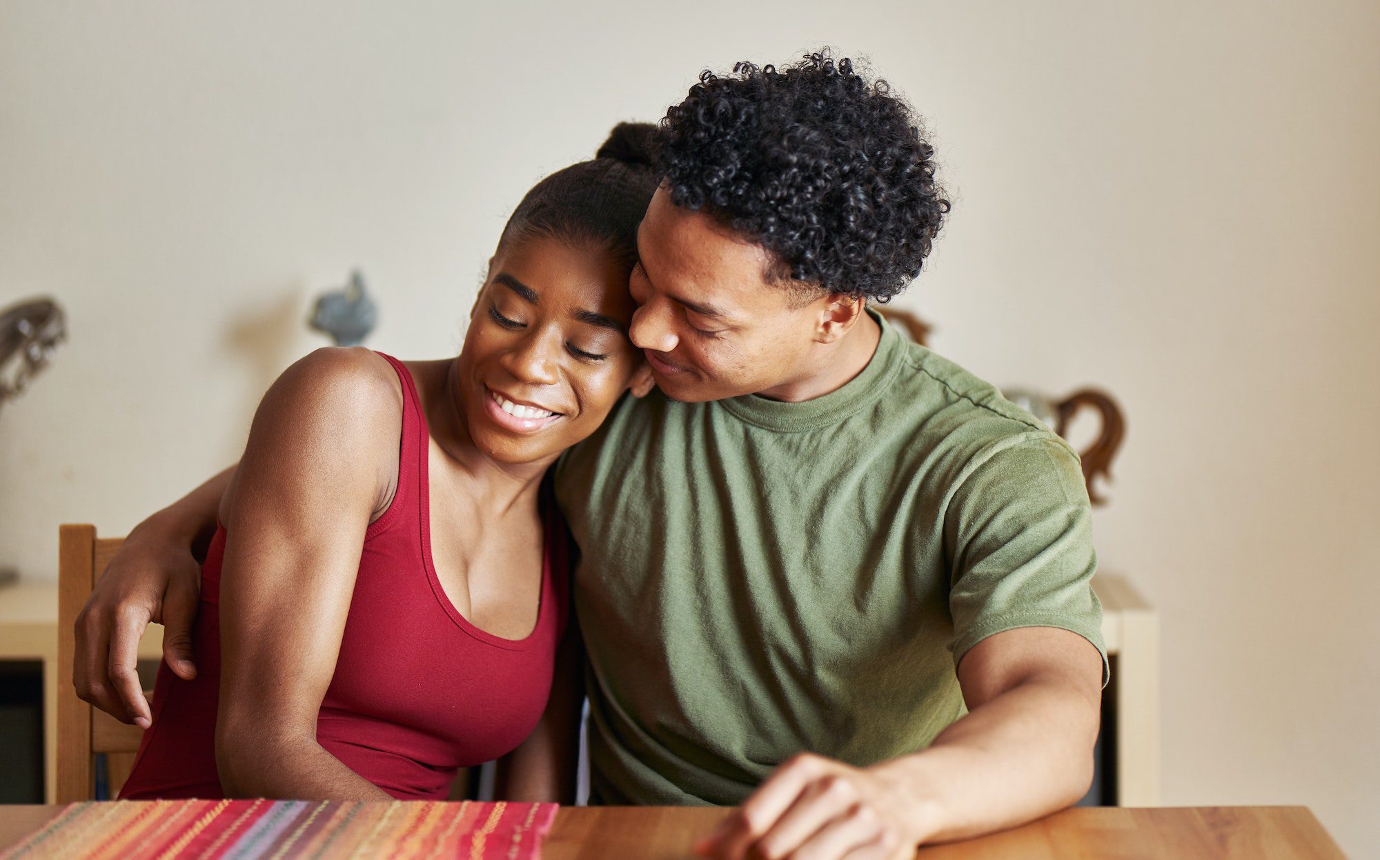 loving african american couple hugging at table