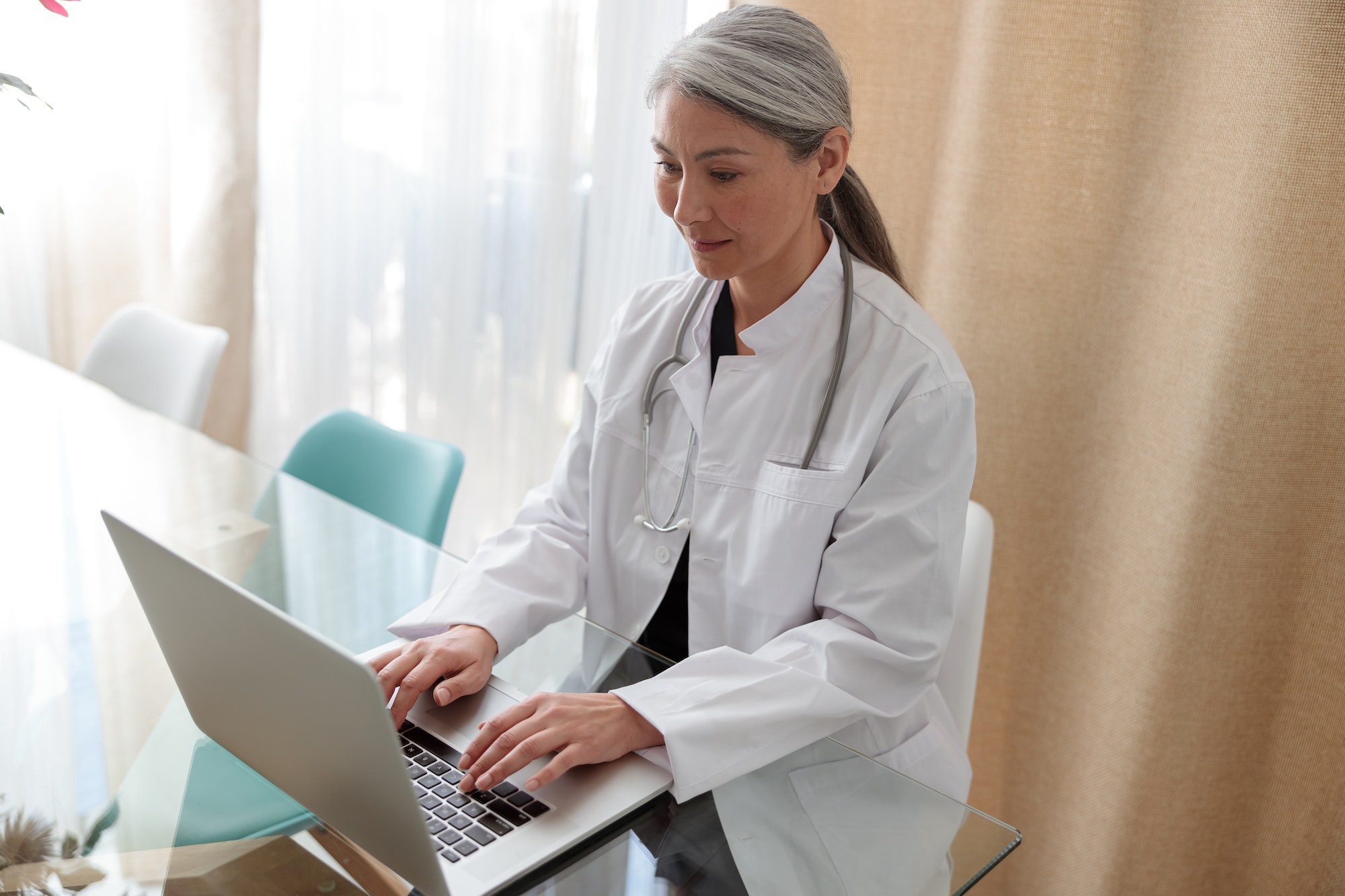 Medical specialist working on laptop at office