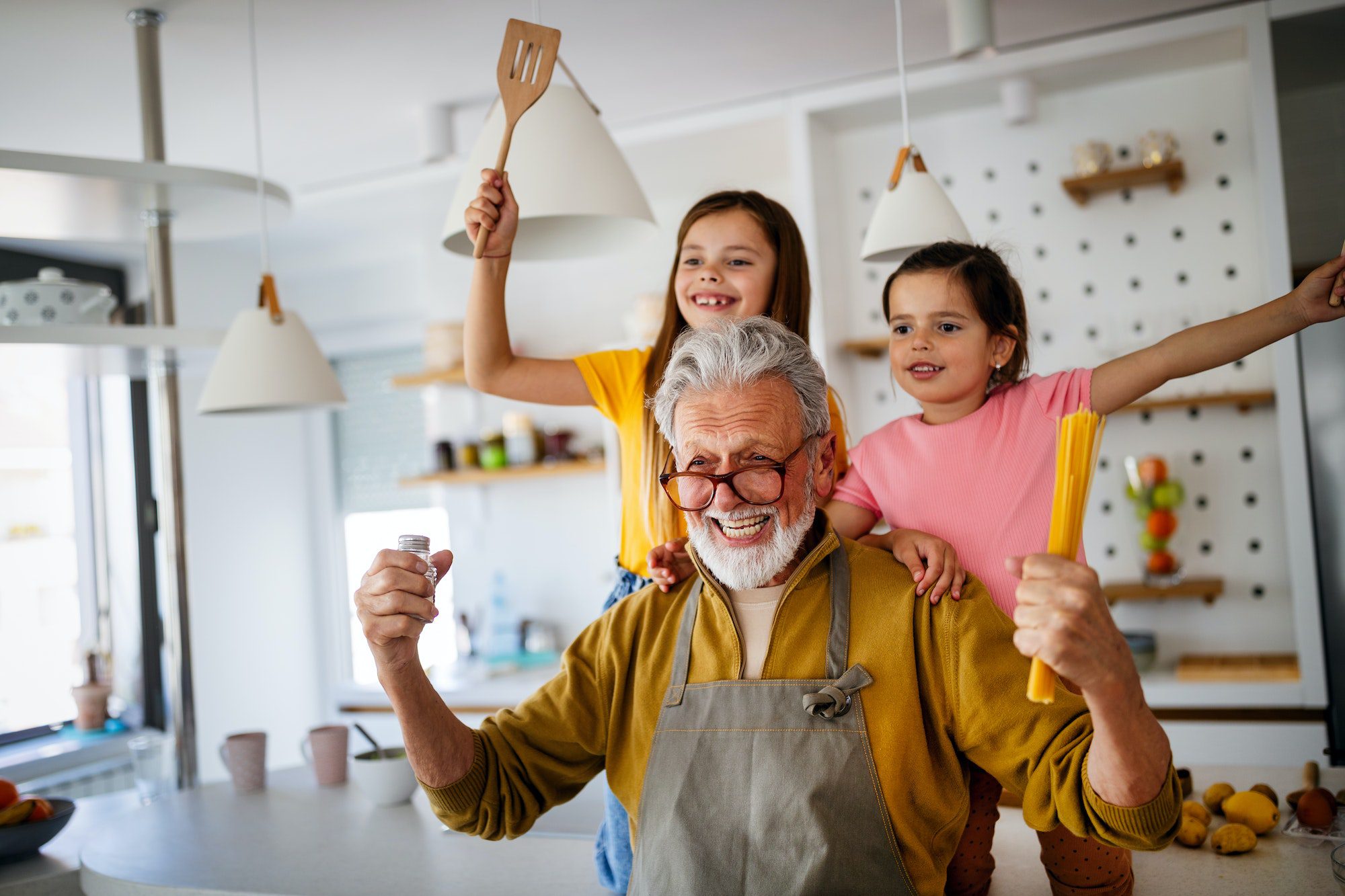 Happy grandparent having fun times with kid at home