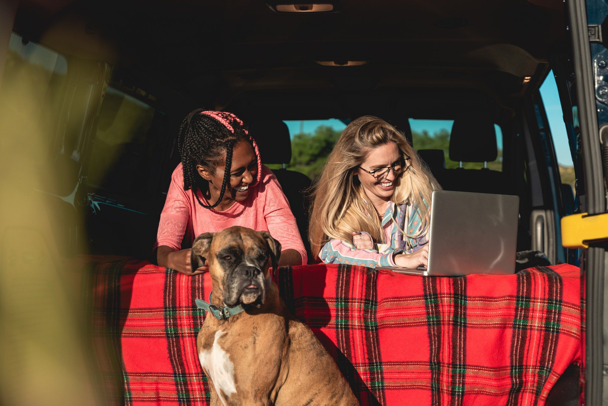 Multiracial people with dog traveling together mini van transport - Digital nomad concept