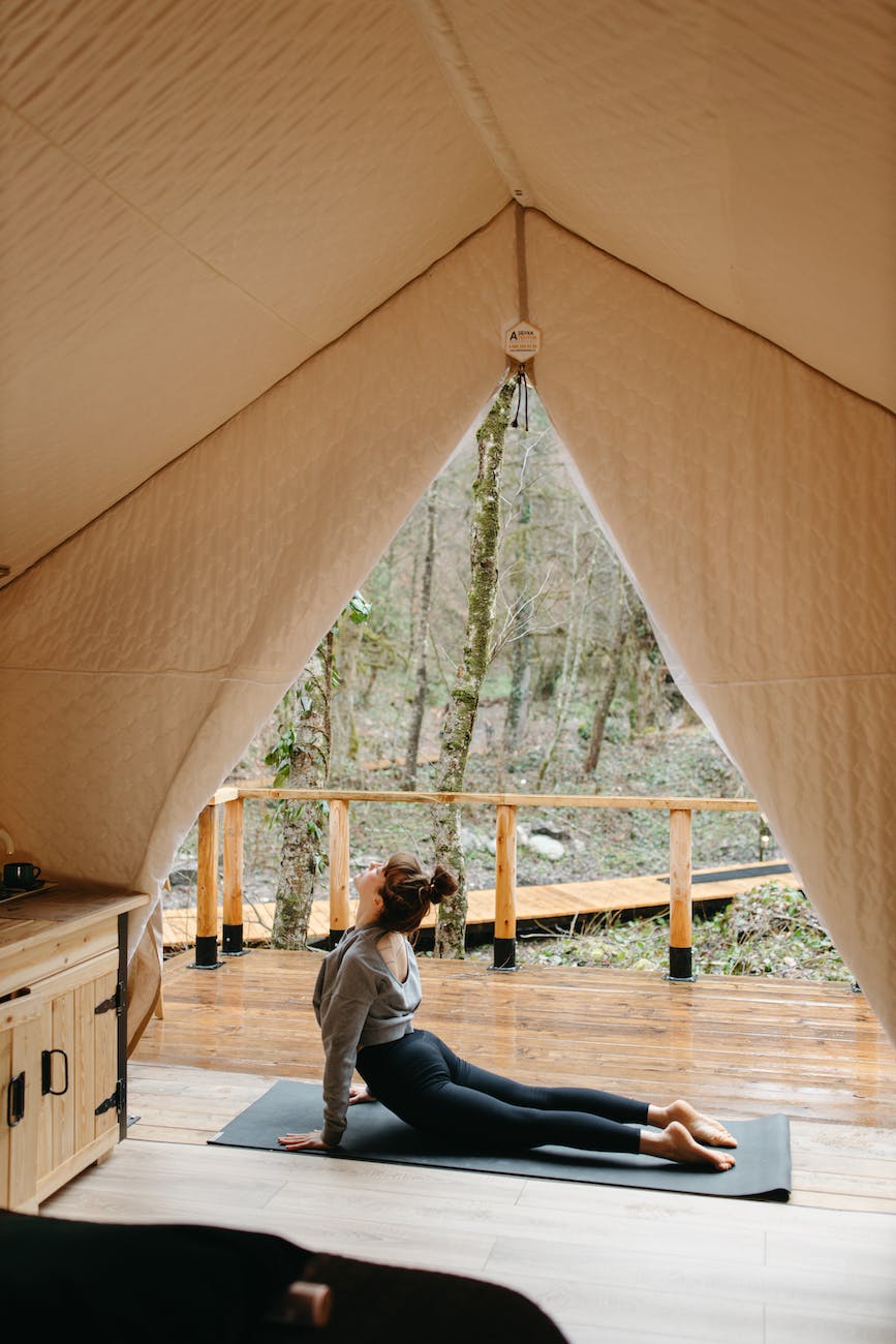 woman in gray long sleeve shirt doing yoga