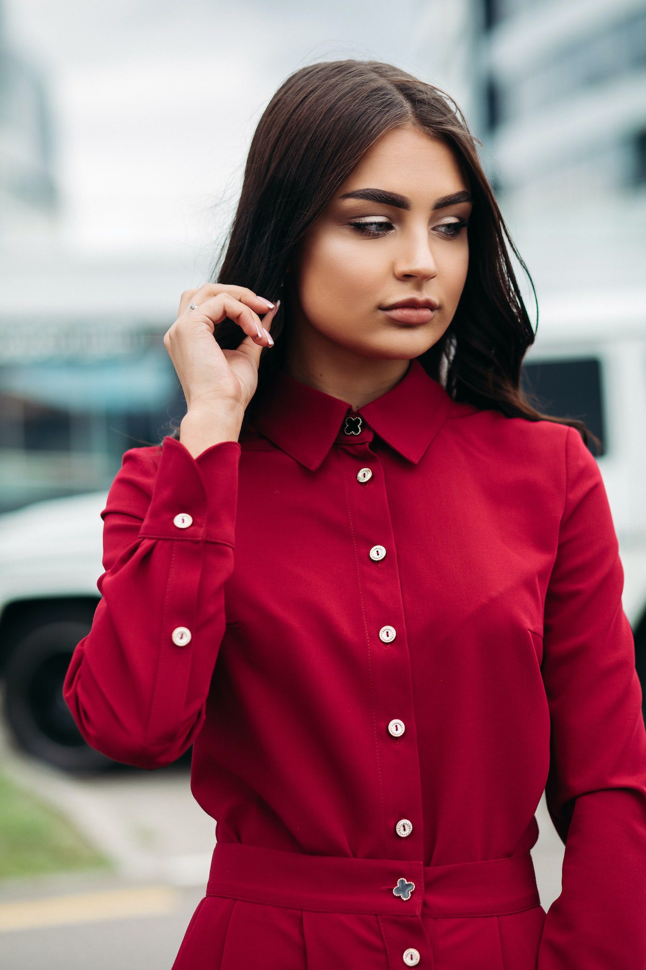 Woman with make up in red buttoned up dress