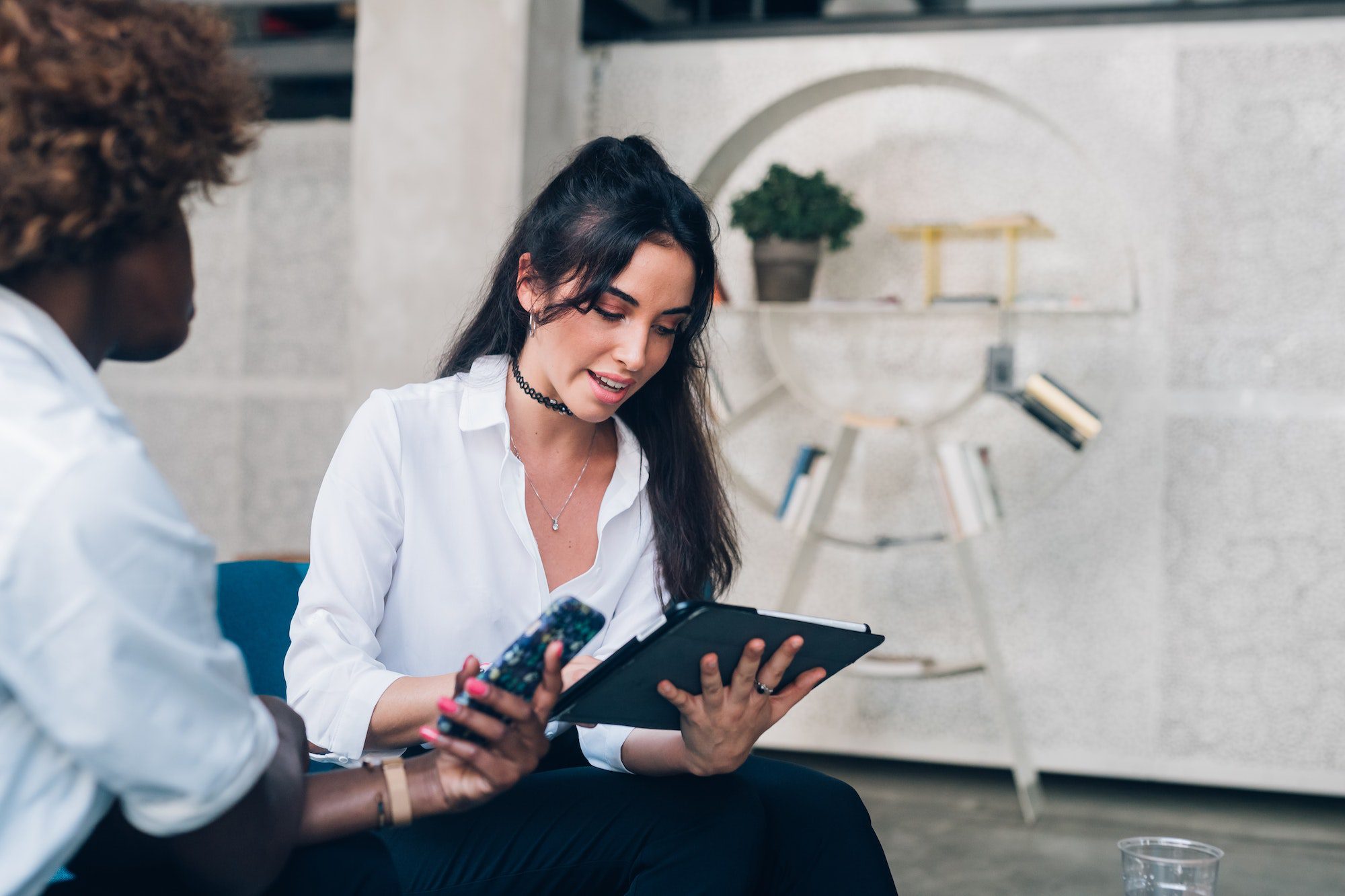 two young businesswomen having meeting in modern office